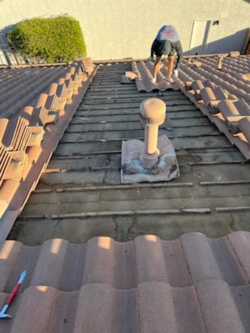 Man Placing The Tiles On Roof