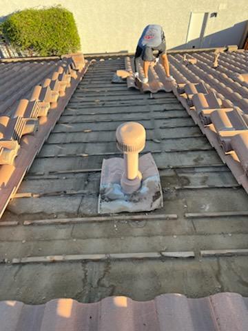 Man Placing The Tiles On The Roof -2